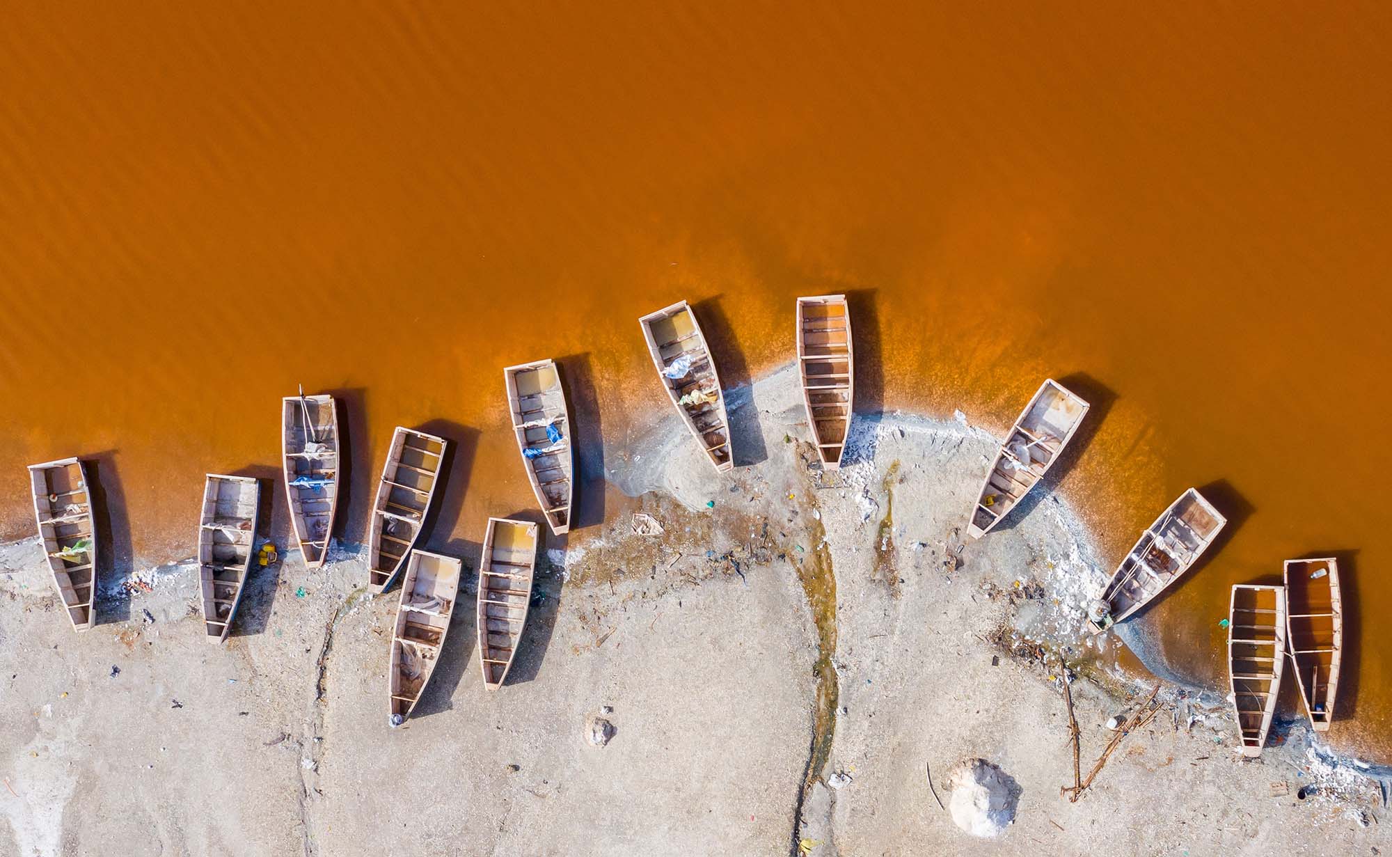 Boats on an orange lake in Senegal