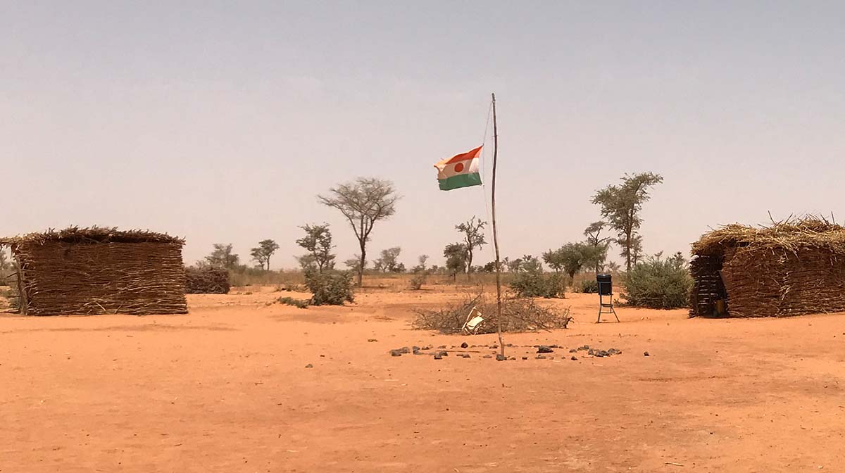 A flag in Niger, located in the desert.