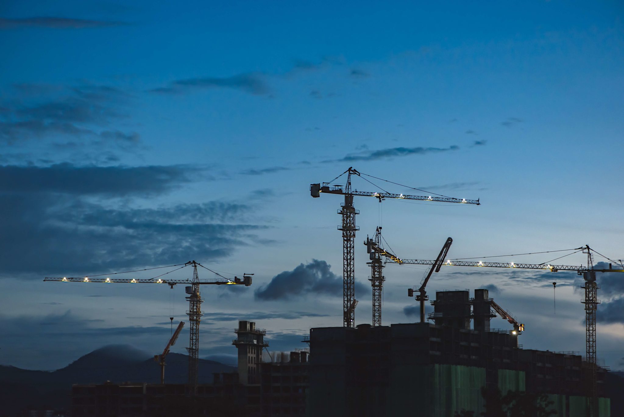 Constructions cranes at dusk
