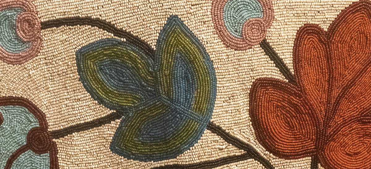 Photo of a First Nations bead artwork from the Royal Ontario Museum. The artwork depicts floral illustrations.